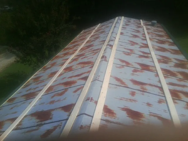 Rusted metal roof panels with new wood purlins before replacement — Storm Damage Roof Repair in Dibble by Roofing Brothers