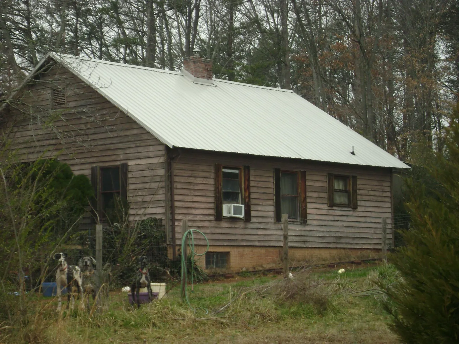 White metal roof on an old wood sided farmhouse, from a Metal Roof Installation job in Dibble